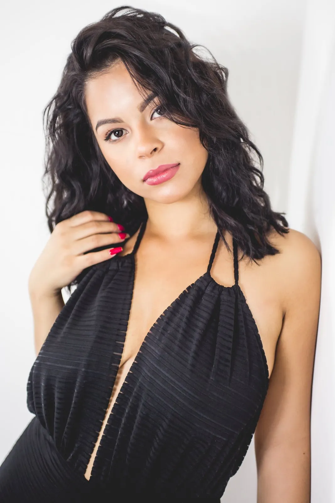 Black halter dress, chin lifted, side light