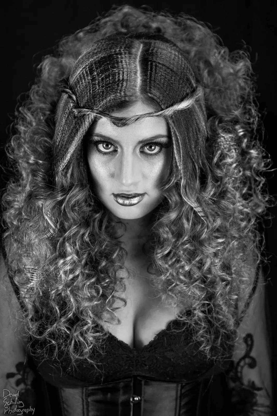 Black and white portrait, hair loose and lit from behind
