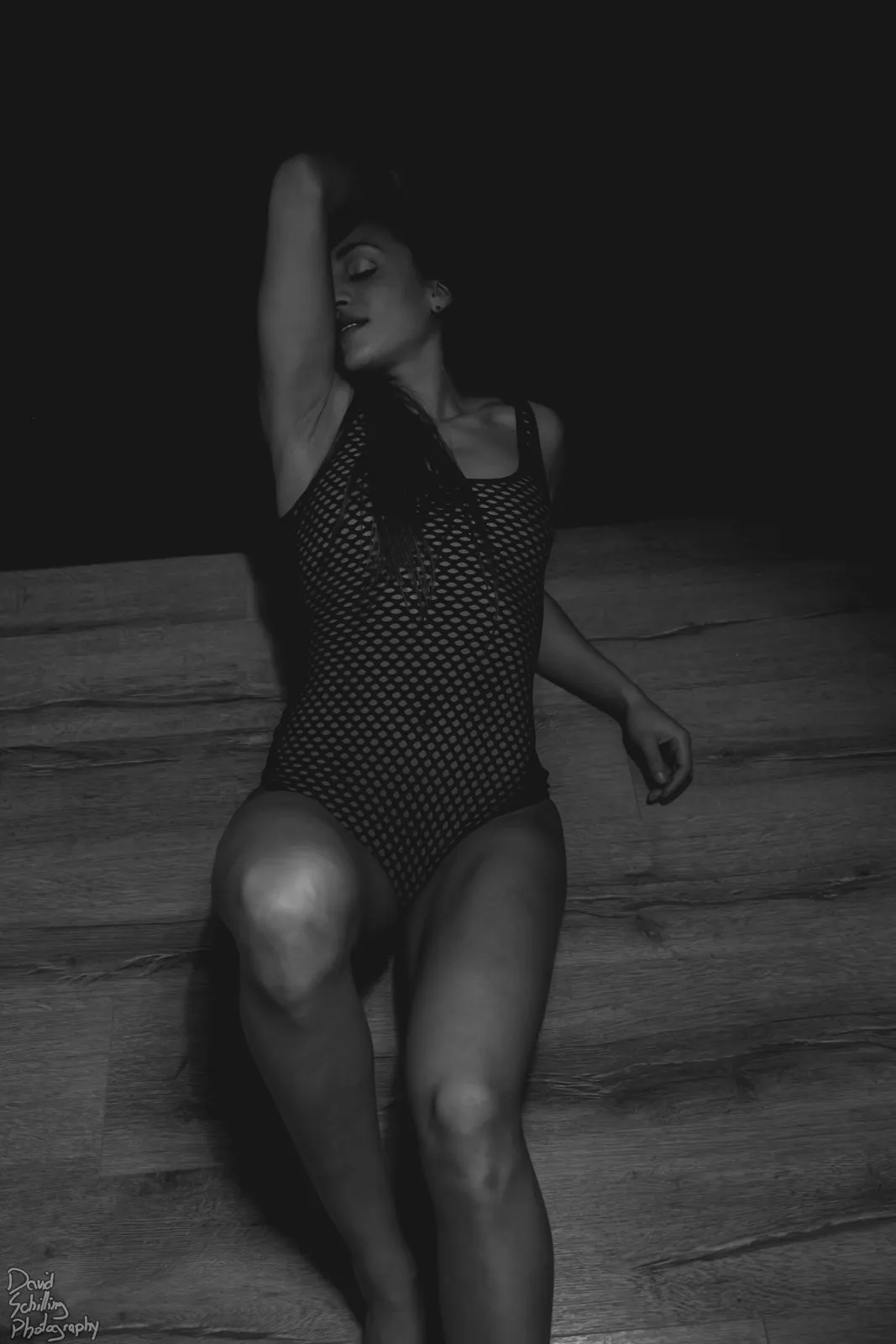 Low-key black and white boudoir portrait