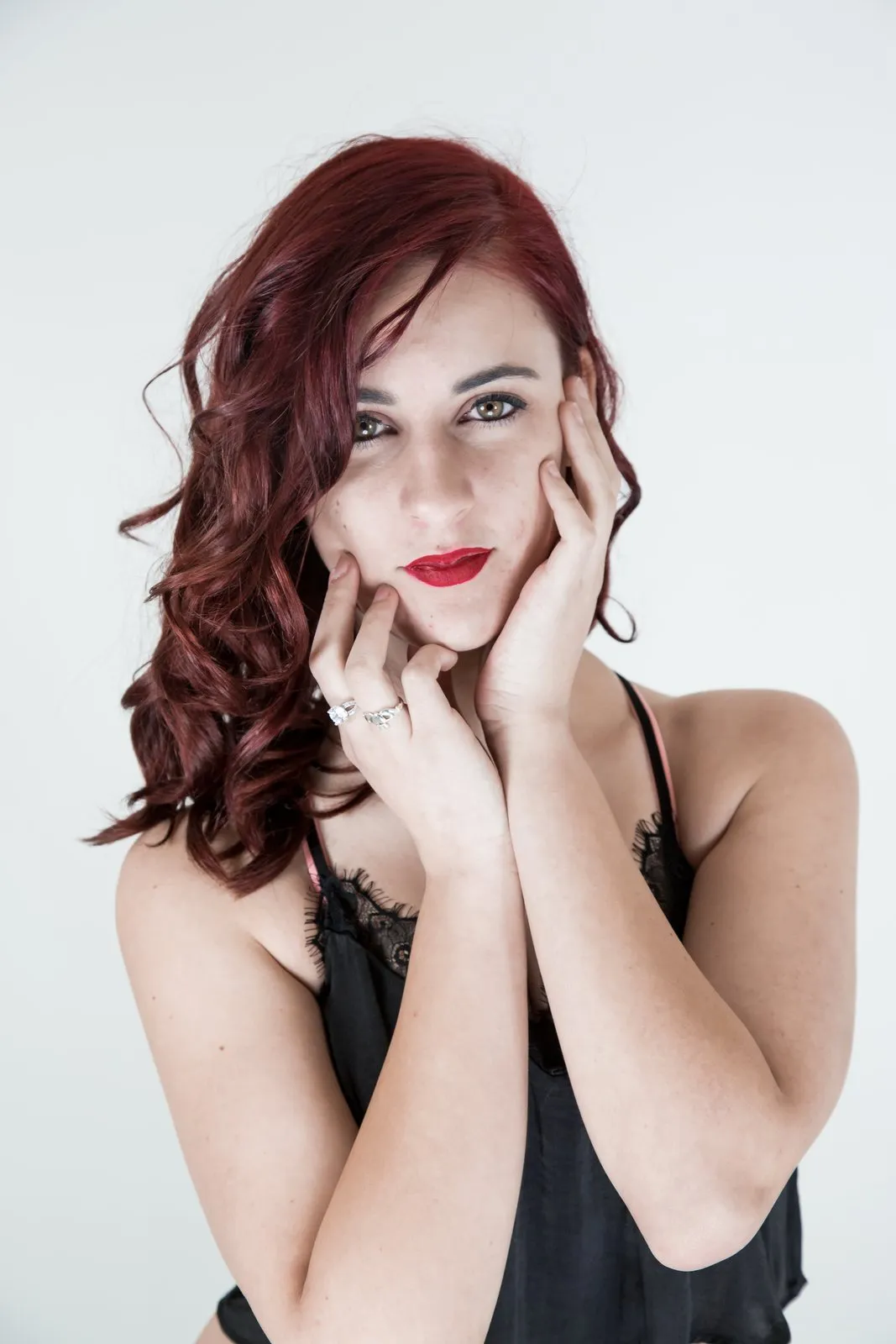 Red hair and red lips, hands framing the face